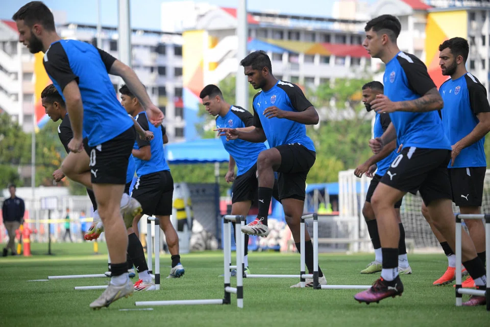 Lion City Sailors captain Hariss Harun putting his best foot forward with Lionel Tan and other teammates during training.