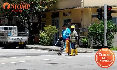 Kind construction worker helps blind man across road at Sims Drive