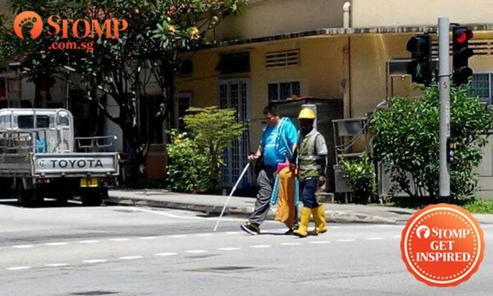 Kind construction worker helps blind man across road at Sims Drive