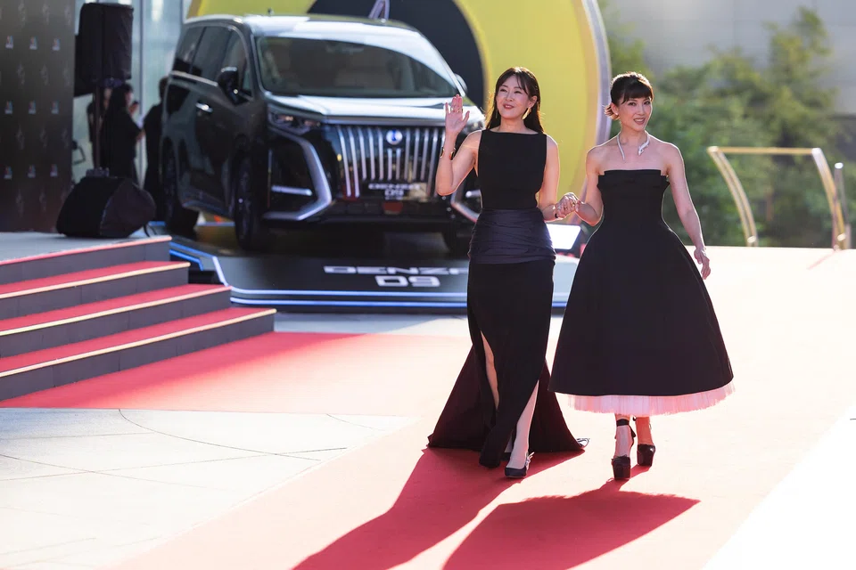 Singaporean actresses Jeanette Aw (right) and Jesseca Liu walking the red carpet at the Star Awards ceremony at Mediacorp on July 6.
