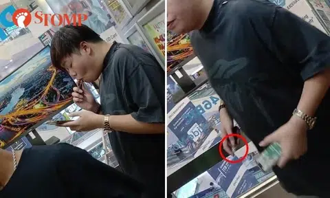 Man vapes in Sim Lim Square lift.