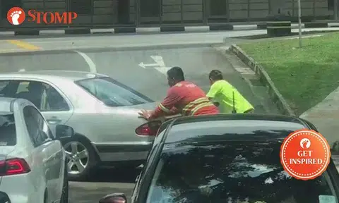 2 kind men help troubled driver push his car until it enters parking lot at Adam Road
