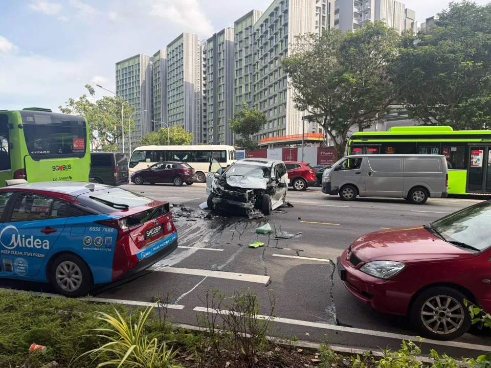 A black car with a damaged bumper and hood was seen on the third lane, with oil and debris surrounding it.