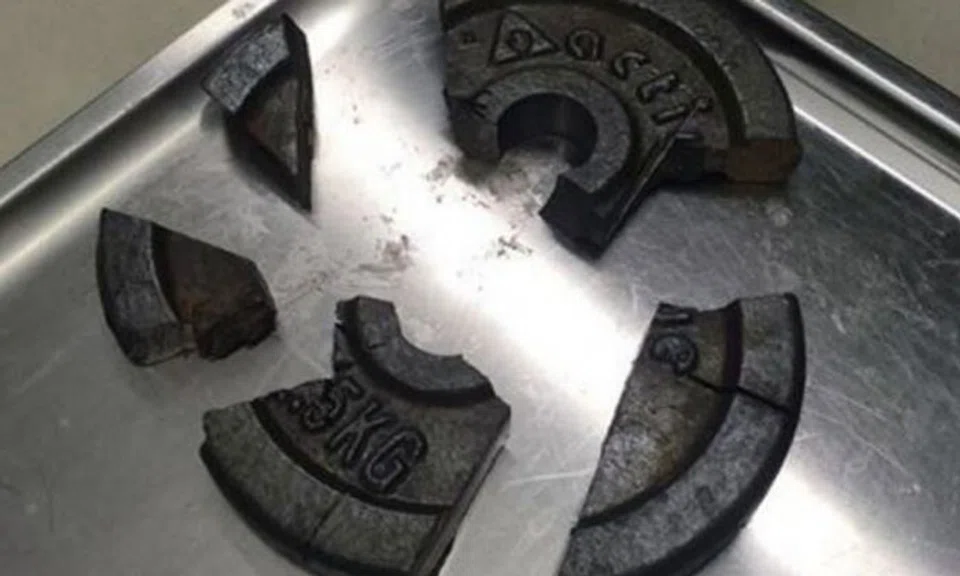 The gym weight plate was broken into five pieces, after firefighters used power tools to free the man from it. 