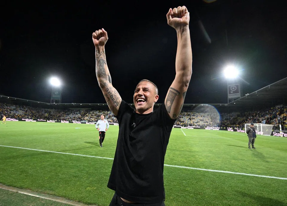 Fabio Cannavaro celebrating after a Serie A match while he was coach of Udinese.