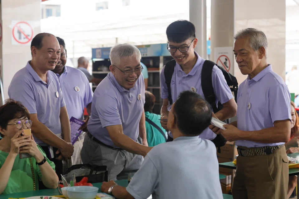 People’s Power Party secretary-general Goh Meng Seng (second from left) and party treasurer William Lim (left) on a walkabout at the Chong Boon Market and Food Centre on April 5.