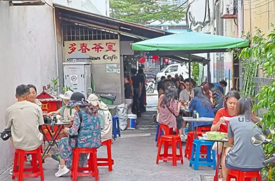Patrons enjoying steamed bread with kaya, half boiled eggs and local coffee at a 70-year-old coffee shop in George Town.