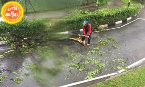 Good guy biker stops to clear fallen branches from road at Jln Bukit Merah