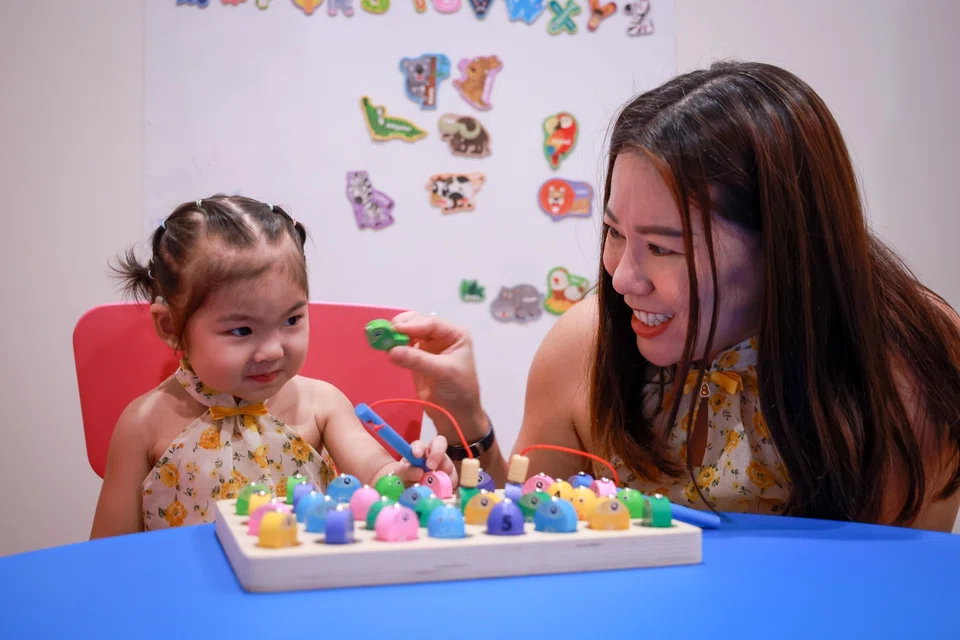 Madam Low Yoke Mui and her two-year-old daughter Yanna Liu, the youngest patient to receive proton therapy at the NCCS Goh Cheng Liang Proton Therapy Centre.