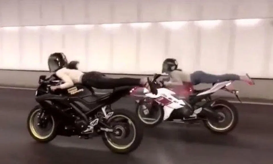 Women perform Superman stunt while riding bikes through tunnel