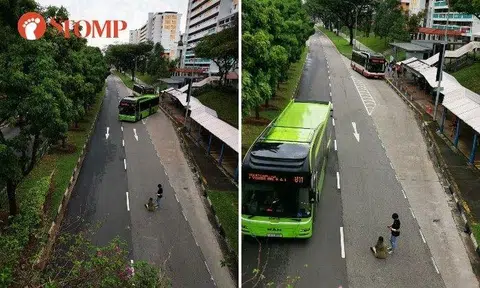 A bus coming from the bus stop had to go to another lane to avoid hitting the two.