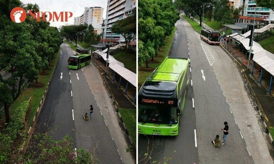 A bus coming from the bus stop had to go to another lane to avoid hitting the two.