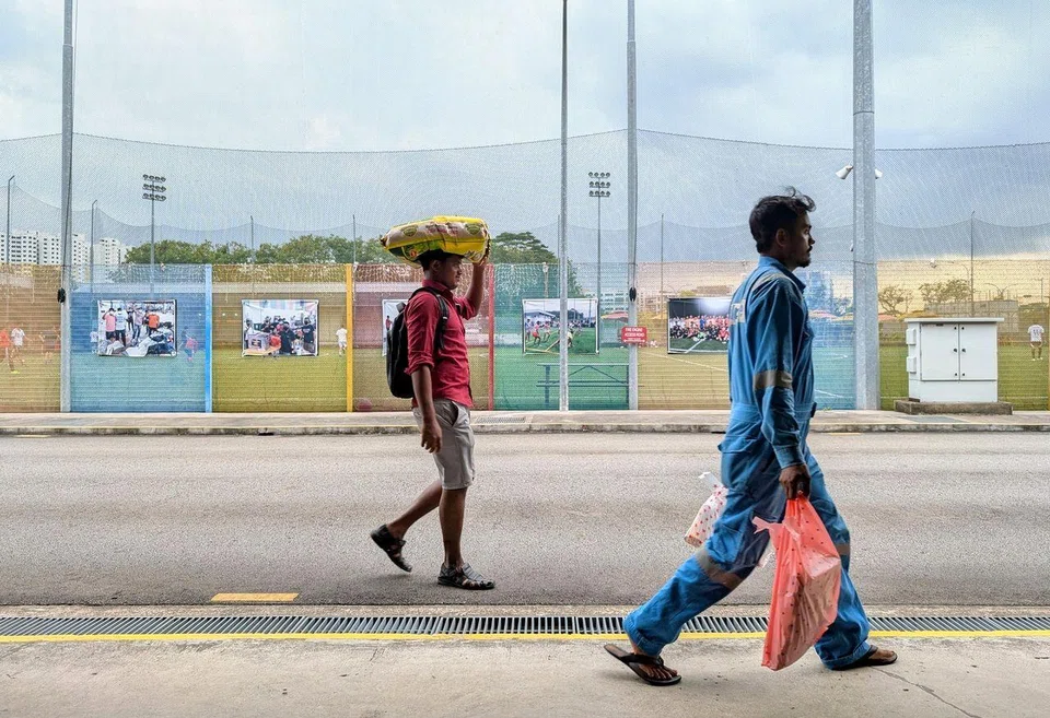 Migrant workers carrying groceries they bought at the minimart in Cochrane Recreation Centre in Sembawang on Feb 16.