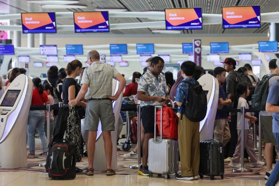 Passengers queueing at Jetstar Asia's check-in counters at Changi Airport Terminal 4 on June 12.
