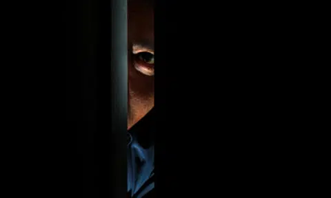 Man and woman charged for conducting surveillance on police officer without approval