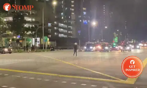Rider helps to direct traffic after lights go out at Punggol Central junction