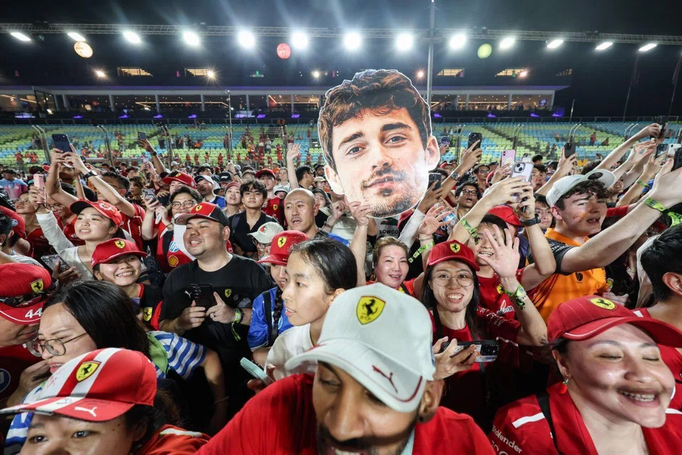 Ferrari fans gathering on the track after the Formula 1 Singapore Airlines Singapore Grand Prix night race at the Marina Bay Street Circuit on Oct 5.