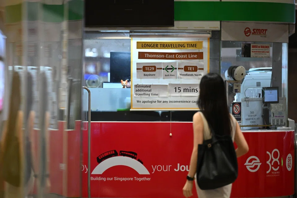 A woman reading a notice at Tampines MRT station about the additional travelling time required between Woodlands North and Bayshore stations on Sept 17.