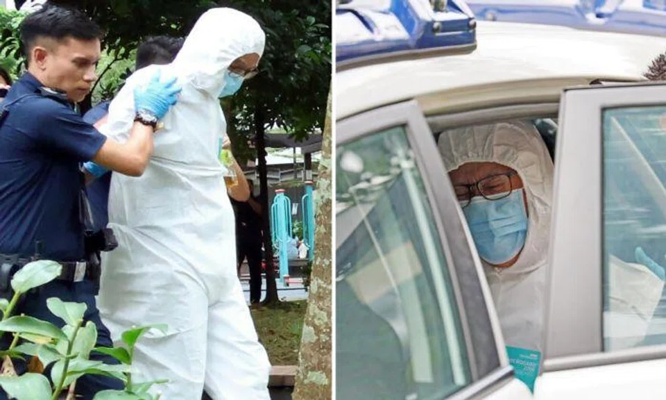 A man covered in full white protective gear which went up to his head was escorted to a police car. 