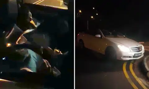 Driver and passenger 'sleep' in Mercedes after leaving it parked in middle of the road at East Coast