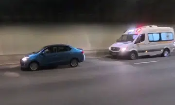 ambulance flashes emergency lights but car in front refuses to budge