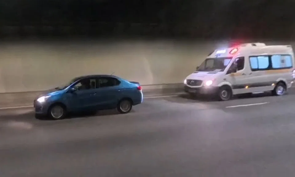 ambulance flashes emergency lights but car in front refuses to budge