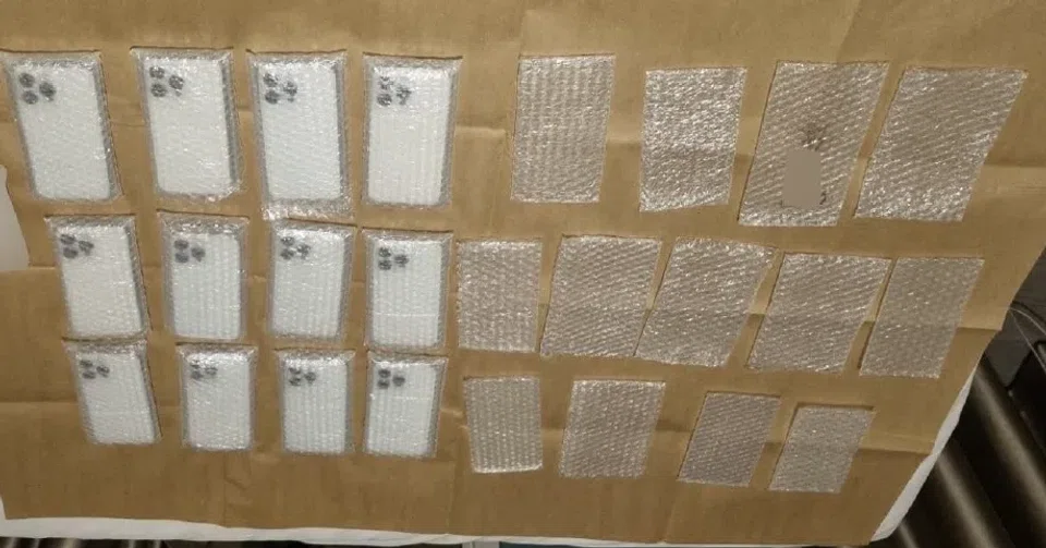 22 counterfeit mobile phones, charging cables, and cash amounting to more than $1,000 were seized.