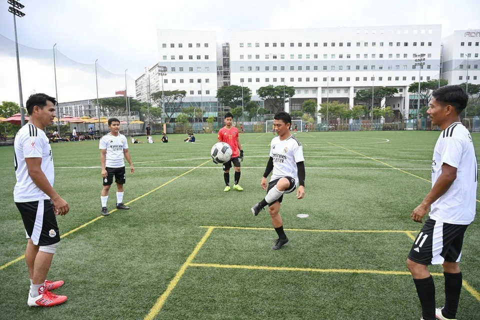 Mr Than Zaw, 26 (second from left), playing football at Cochrane Recreation Centre on Feb 16 with other migrant workers from Myanmar who also live in Cochrane Lodge 2 in Sembawang.