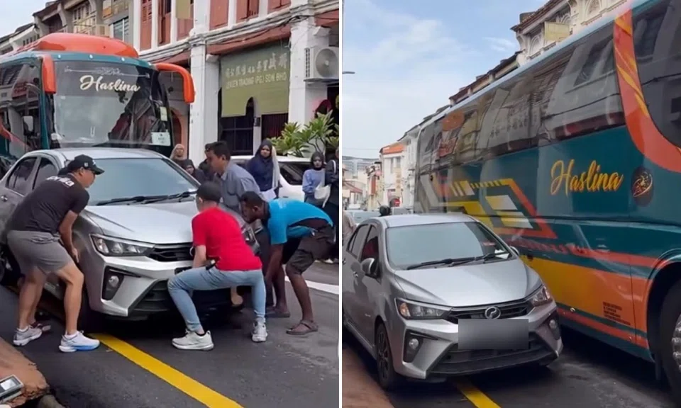 Car blocks alley in George Town, Penang, so strangers team up to lift it and clear the way