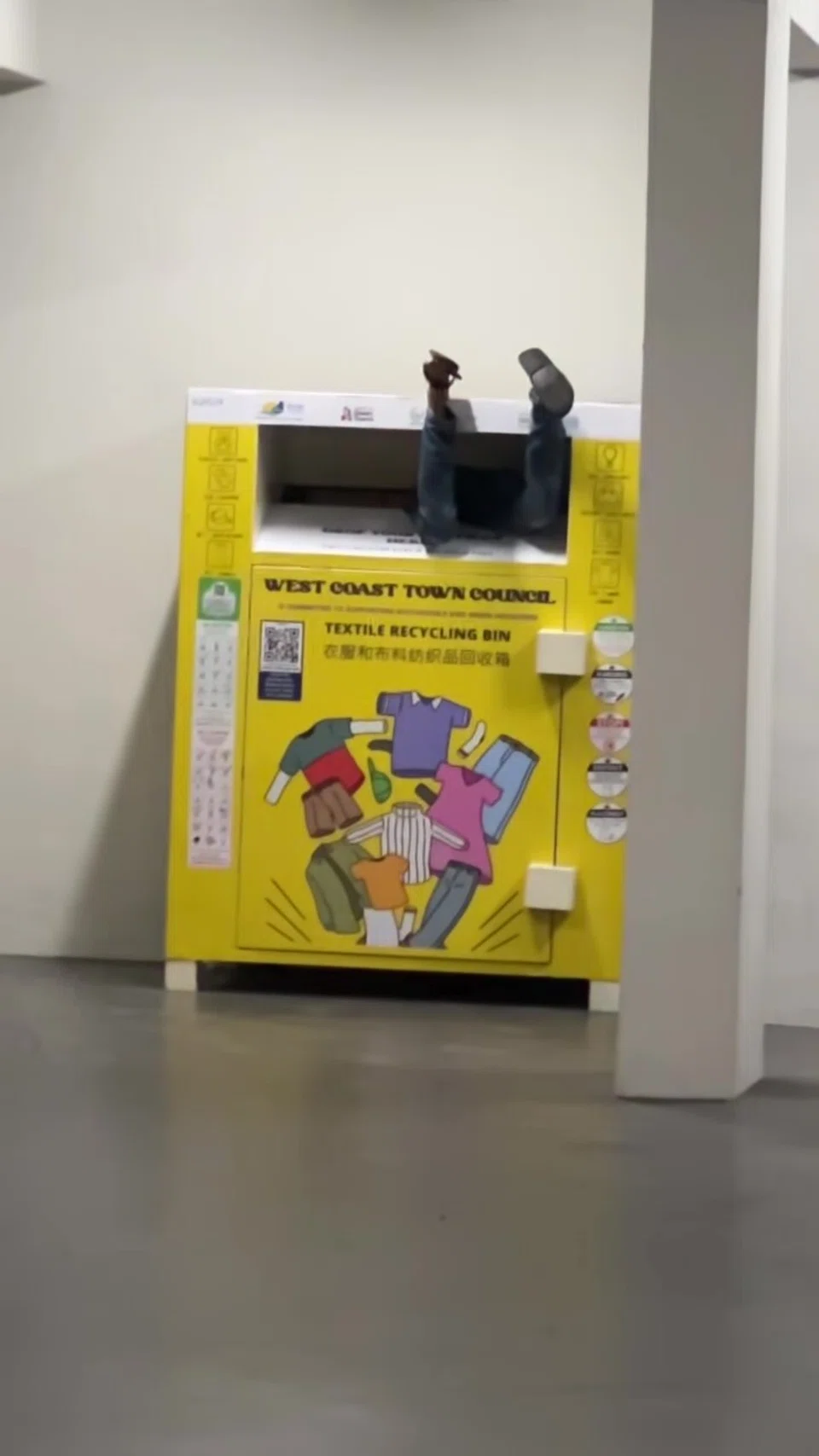 Man’s legs stick out of Jurong West recycling bin