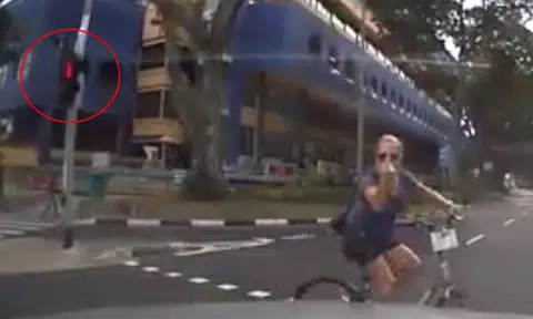 Cyclist beats red light, doesn't dismount when crossing road -- yet gives driver the finger