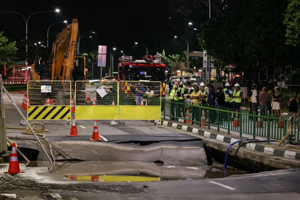 Water being pumped out of the sinkhole along Tanjong Katong Road South on July 26.