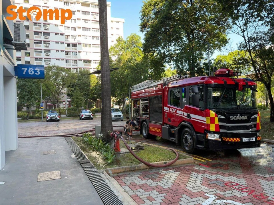 SCDF vehicles and police cars were parked at the foot of the block.