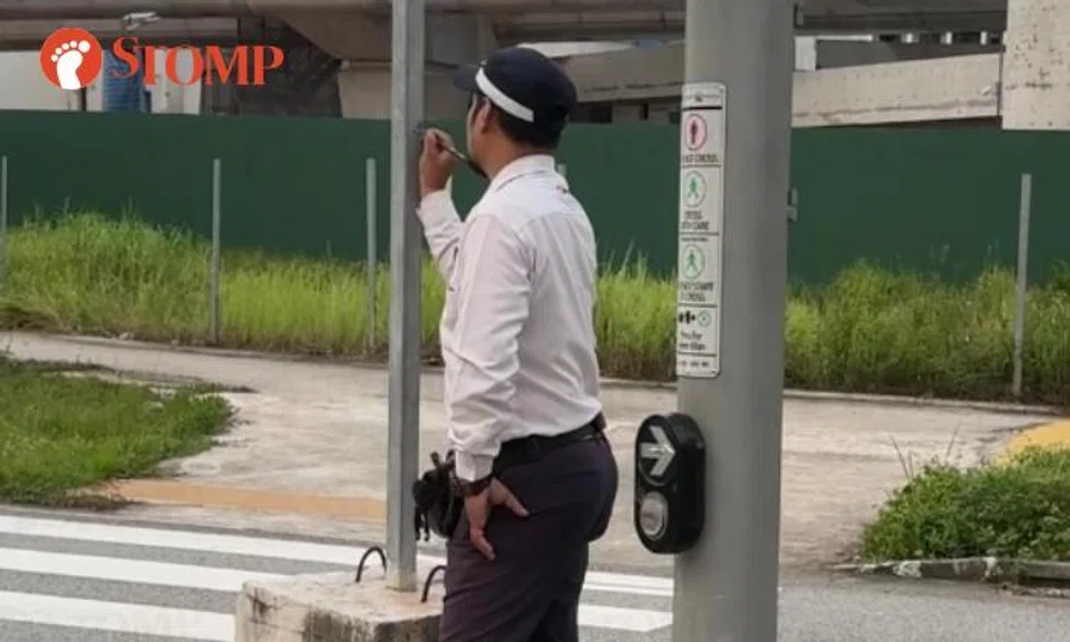 Traffic officer doodling on sign post
