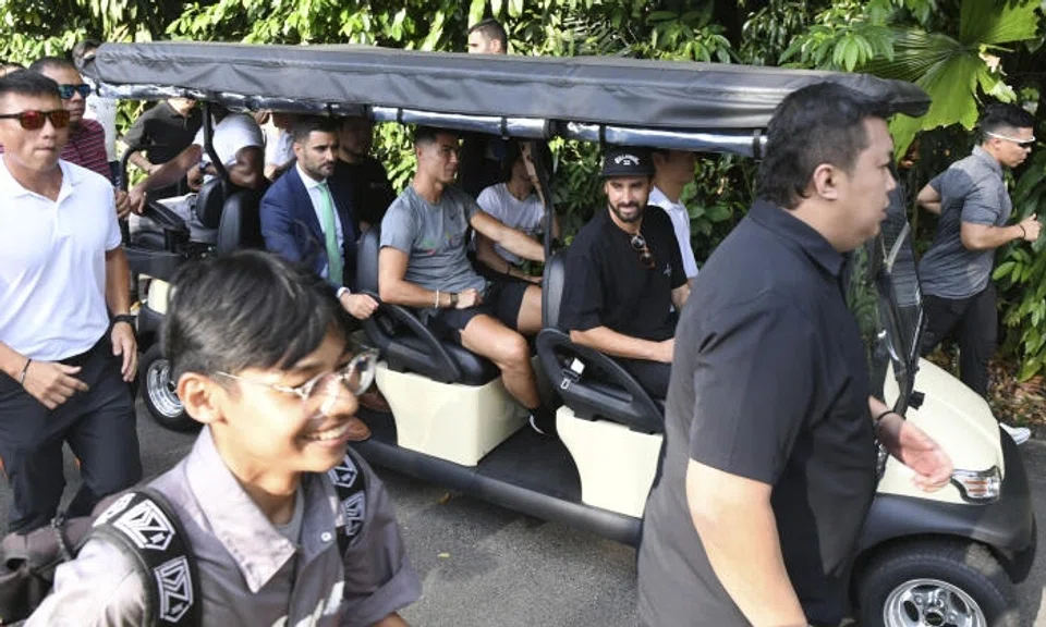 Ronaldo made a whirlwind, 15-minute appearance as he arrived in a grey top, black Nike shorts and black trainers, flanked by his entourage and security detail. Photo: The Straits Times