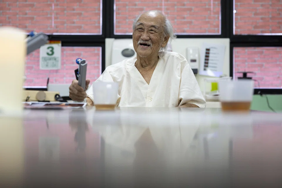 Mr Tan Siong Par, who has dementia, playing the tone chime during a music therapy session at St Luke’s Hospital.
