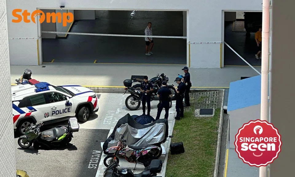 Police in the carpark at Block 235 Choa Chu Kang Central with the area cordoned off.