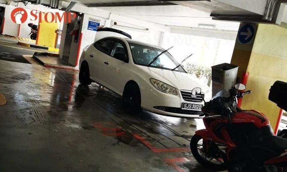 Stomper Joy shared a photo of the white vehicle on the wet floor with its windshield wipers up and rear boot open.