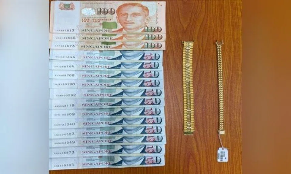 Cash amounting to $900 were recovered from the man as well as the bracelets. Photo: Singapore Police Force
