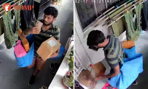 Delivery man throws parcel onto ground and shoves it with shoe, breaking glass item inside