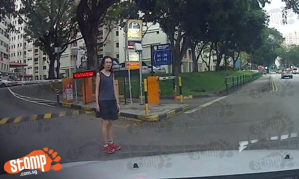 Pedestrian crosses road without checking for traffic, gives driver stink eye for honking at her