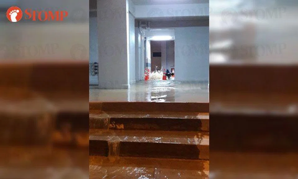 Water gushes from void deck of Hougang HDB block due to leak