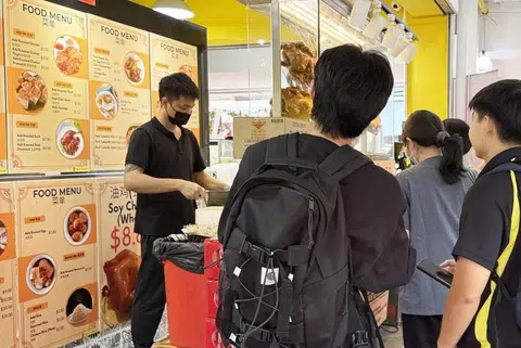 Customers flocking to chicken rice stall for a $1.90 meal.