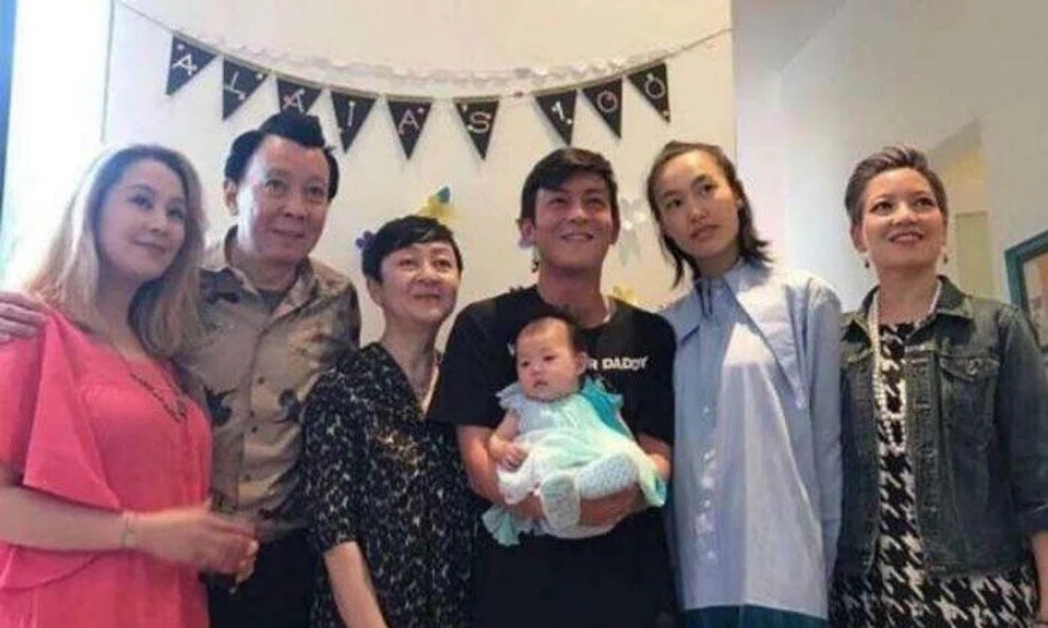 Edison Chen holds up a baby girl, flanked by Chinese-born model Shu Pei Qin, his parents and his two older sisters. PHOTO: INSTAGRAM