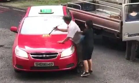 An elderly man was caught on video hitting a taxi while a little boy restrains him