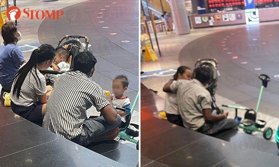 Passer-by concerned to see helper behaving intimately with man while looking after kids