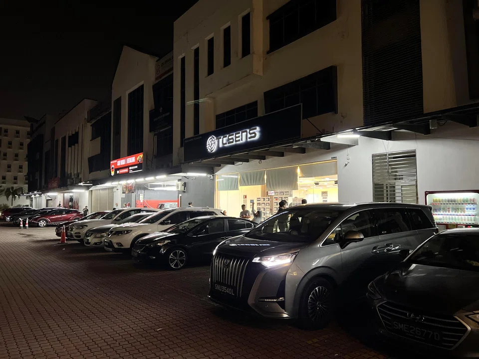 Singapore-registered vehicles seen parked outside the 24-hour TCSens VEP enquiry centre at Danga Bay at 8.30pm on June 30. 