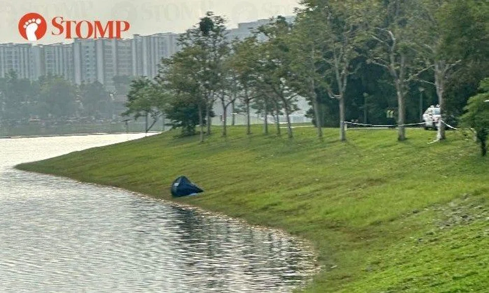 Stomper John shared photos of a blue police tent on the grass near the water and police cars parked nearby.