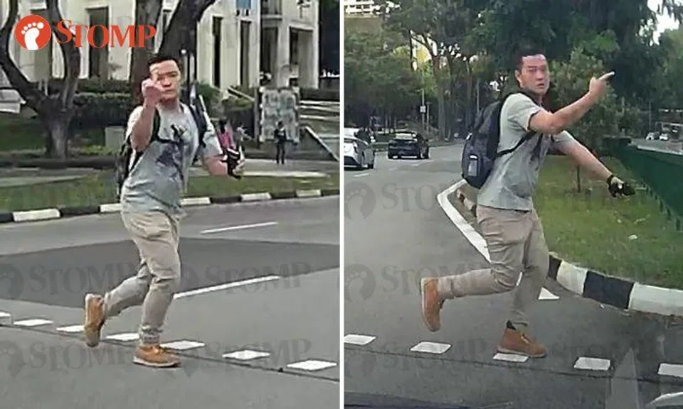 Man runs across road during red light -- and still has the cheek to point middle finger at driver