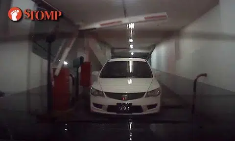 Driver tailgates car past Mandarin Orchard carpark gantry, turns off headlights to be tactical